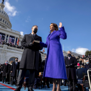 Outside the U.S. Capitol Building, Kamala Harris places her hand on a Bible held by a man